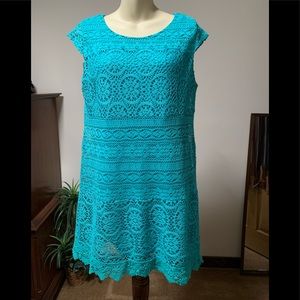Crocheted sheath turquoise dress with polyester lining.